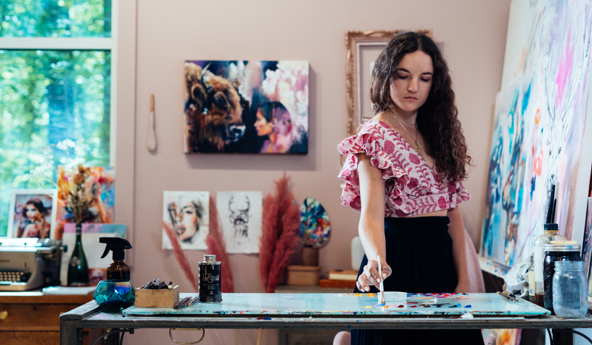 girl using paint pallet in pink shirt